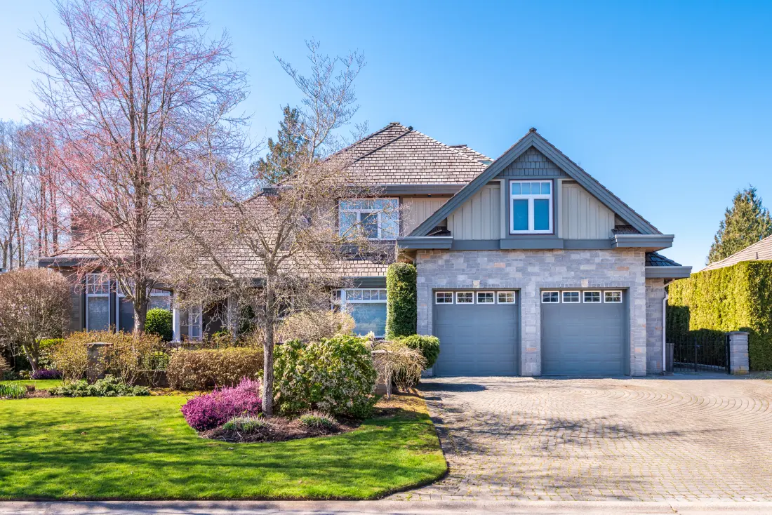 A well-kept two-story home with a stone-accented garage